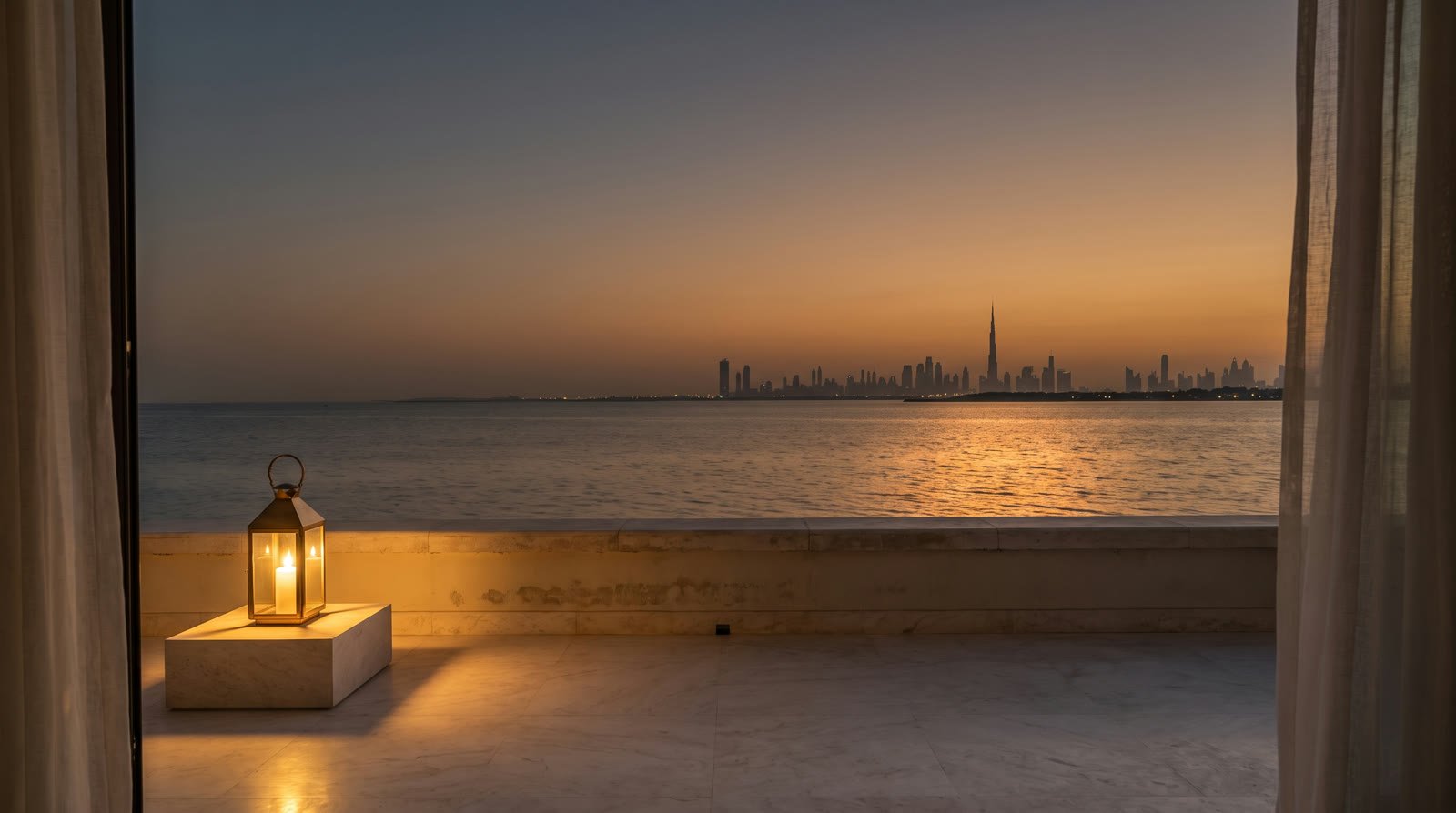 A beach-house terrace at dusk with the Dubai skyline across the water